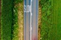 aerial view of road and green fields by red zeppelin