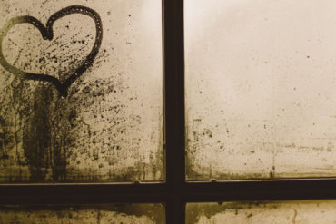 love heart marked into dust on window of derelict property by gaelle marcel