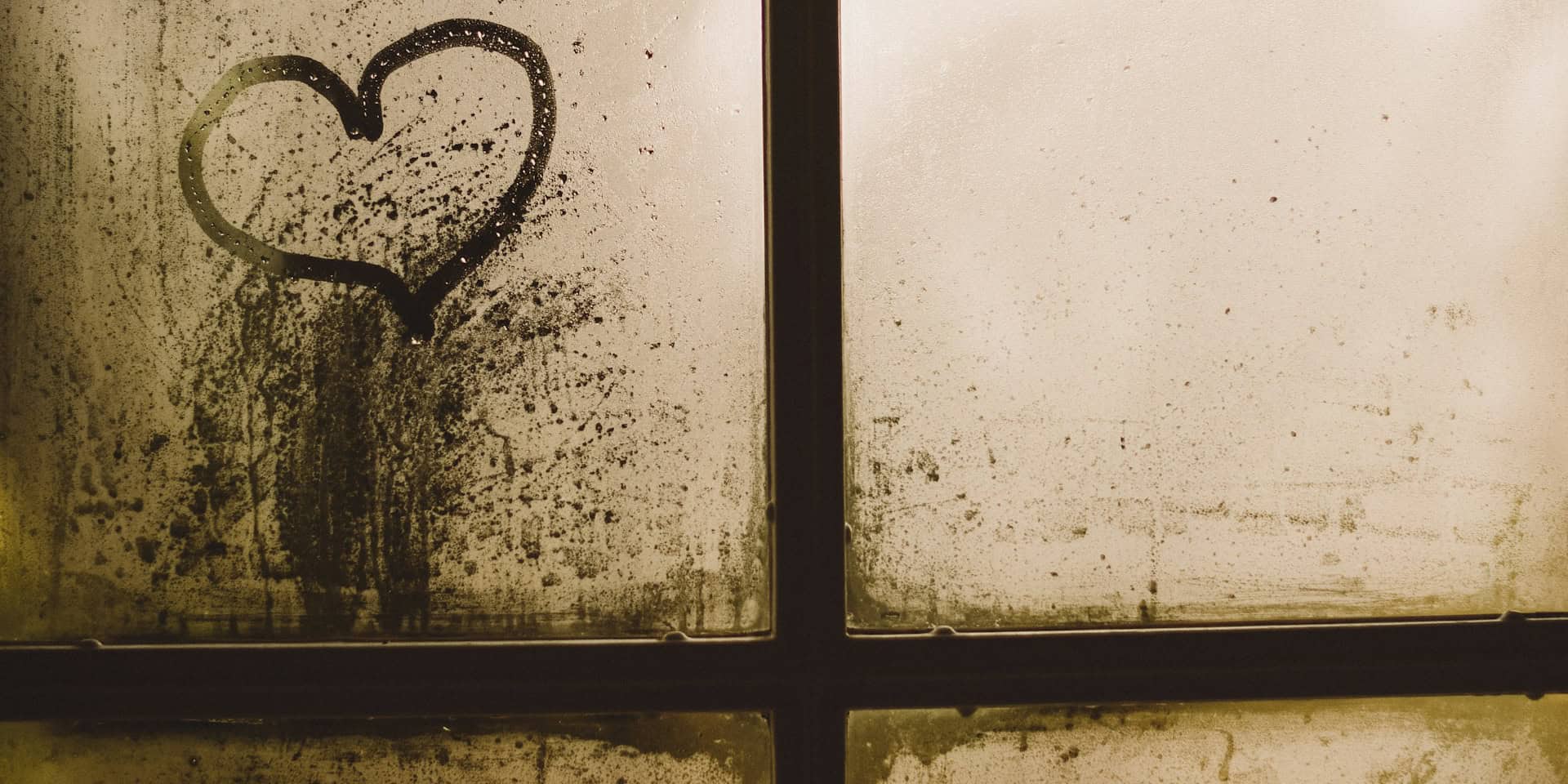 love heart marked into dust on window of derelict property by gaelle marcel