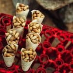 paper cones of peanuts being sold at the side of the road in India