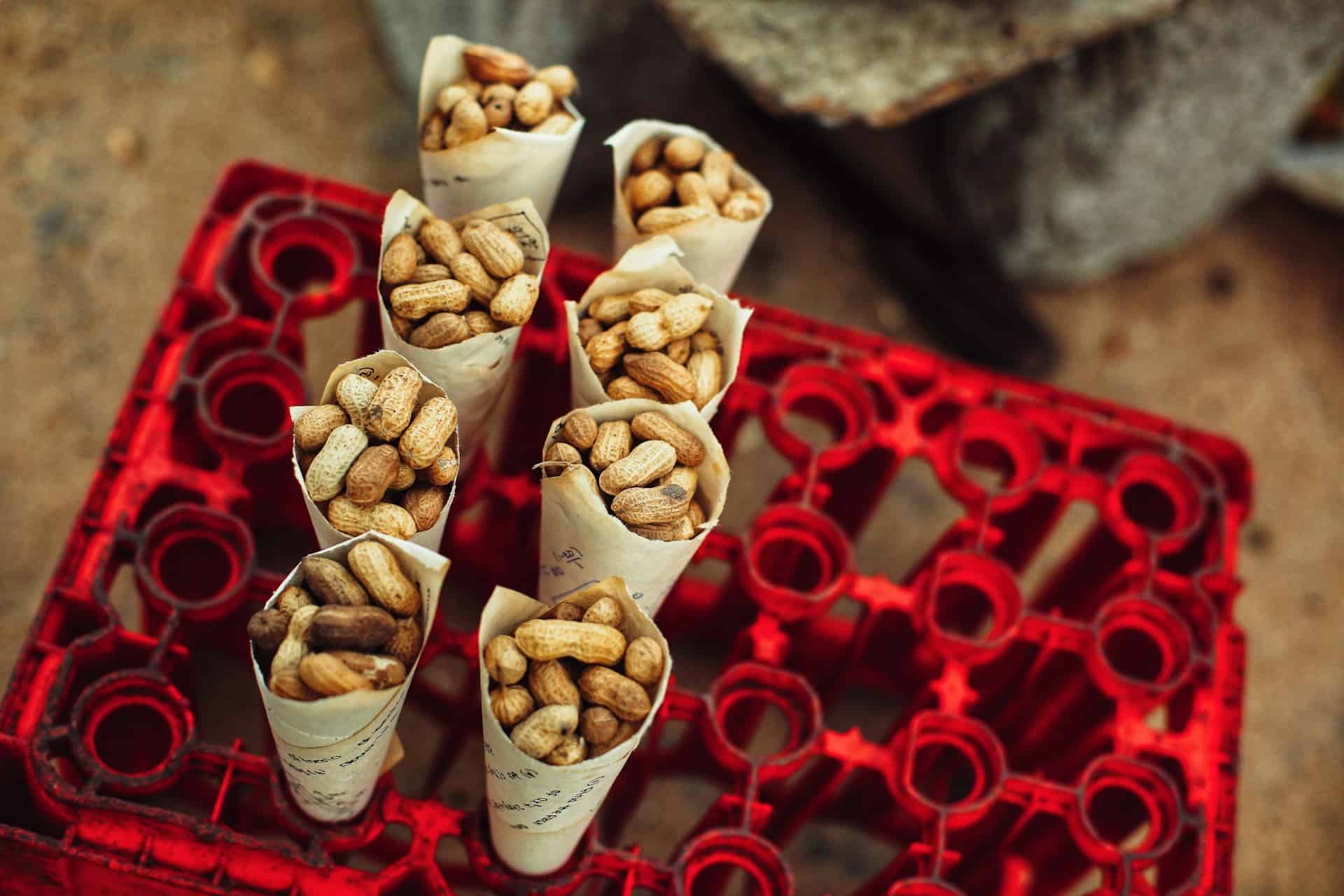 paper cones of peanuts being sold at the side of the road in India