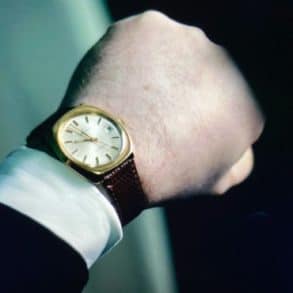 person looking at wrist watch by claus friede