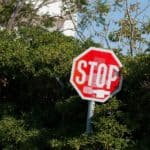 stop road sign in a bush