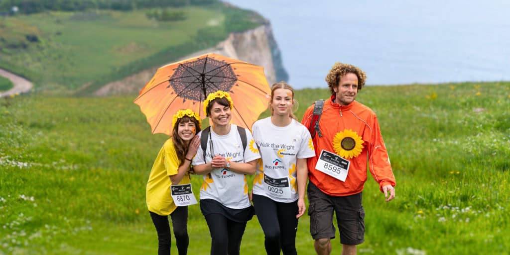 Four family members smiling at the camera whilst taking part in Walk the Wight