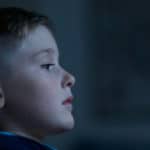 young boy child leaning against wall looking sad and lonely by luke pennystan