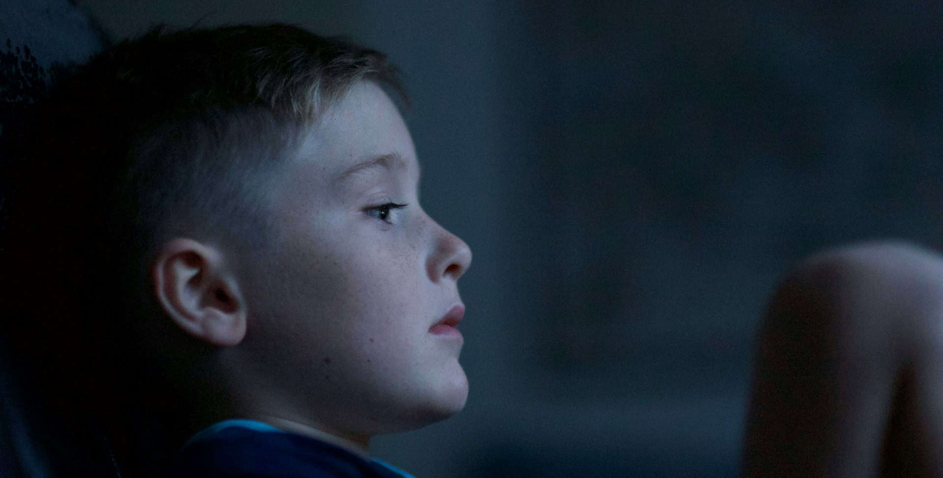 young boy child leaning against wall looking sad and lonely by luke pennystan