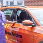 Mountbatten nurse standing by a car