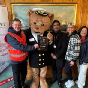 Official certificate presentation with dancing man jim, Ted Funnel and Saints Foundation members