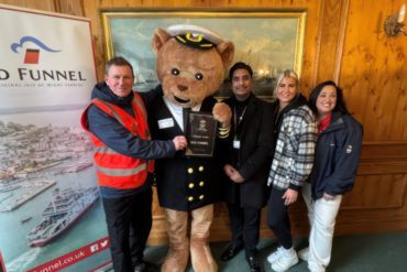 Official certificate presentation with dancing man jim, Ted Funnel and Saints Foundation members