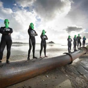 SAS swimmers standing on sewage pipe leading out to sea