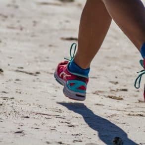 Woman running on the beach by dulcey lima