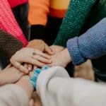 girl friends hands piled together