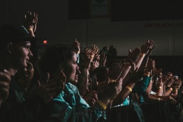 group of people in audience applauding