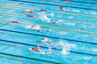 men competing in swimming competition