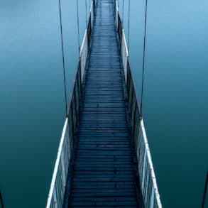 wooden bridge over blue lake