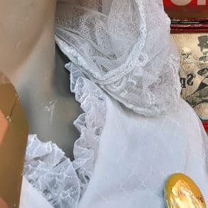 Mannequin with wedding dress and unpacking packs badge