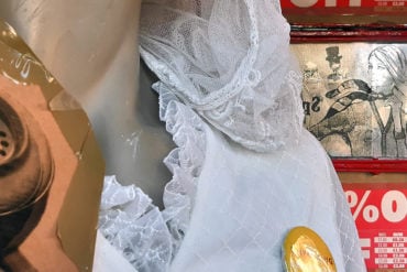 Mannequin with wedding dress and unpacking packs badge