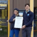 Innerspaces staff with certificate showing they are signed up to the Tick Box scheme