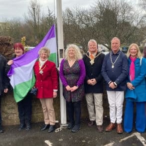 Karl Love with women at IWC raising the flag