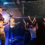 The Optimists playing on the stage at Strings Bar and Venue by David Rutherford