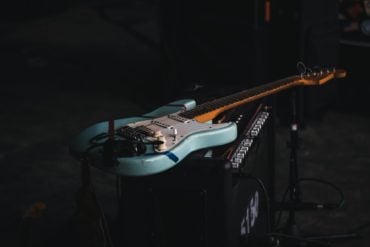 electric guitar placed on an amp