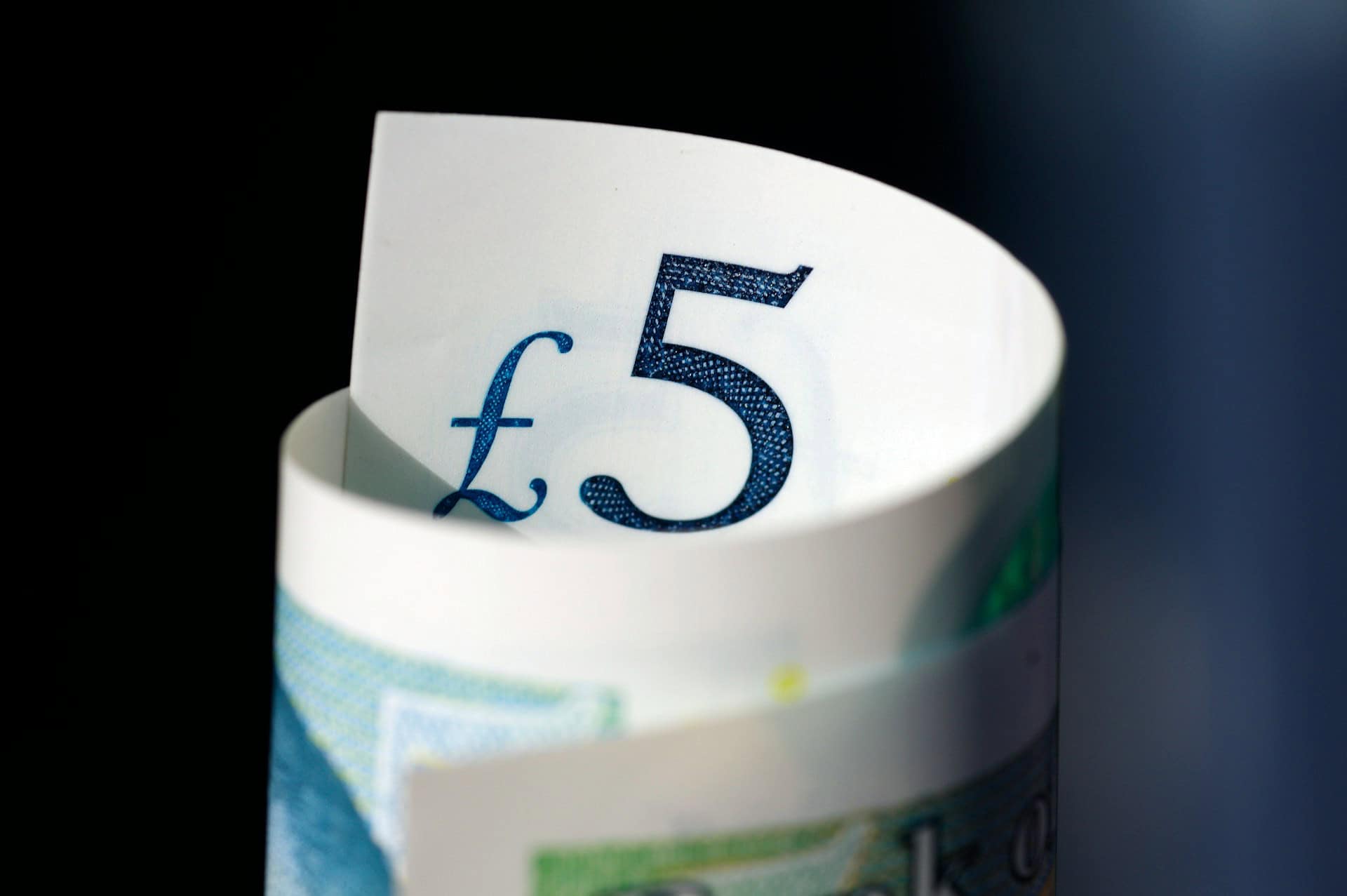 rolled up five pound note