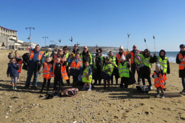 People litter picking on Sandown Beach