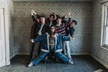 Caught Short band portrait standing together in a room