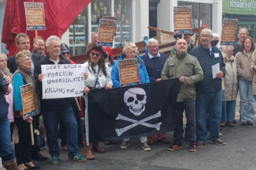 Joe Robertson and protestors (some dressed as pirates) in Cowes
