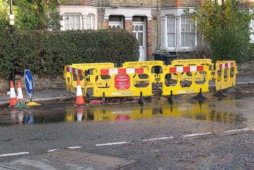 Barriers around a water leak in a road