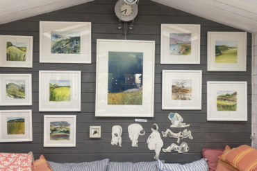Framed Paintings hanging in Birgit's studio