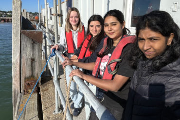 Izabella, Gala, Rithu and Lekshmi prepare to lower the cuttlefish nurseries beneath Ryde Pier