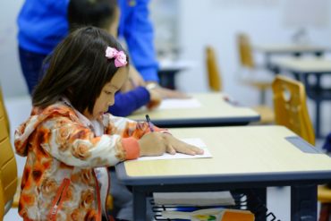 a primary school pupils sat working at a desk