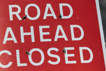 road ahead closed sign