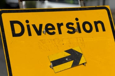 yellow diversion road sign