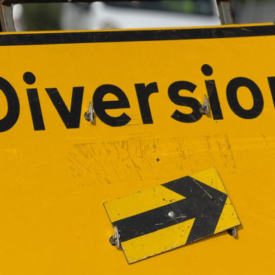 yellow diversion road sign