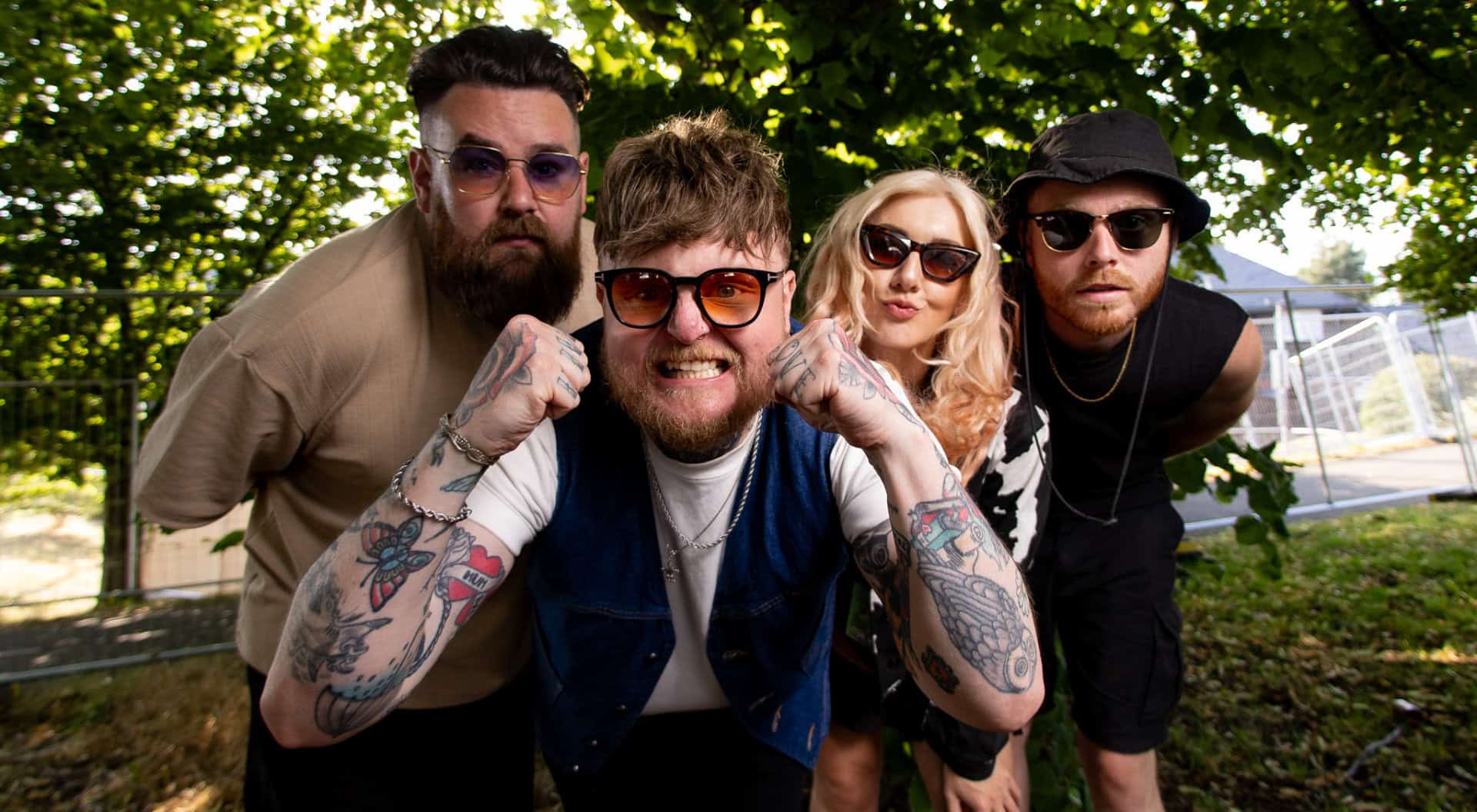 Lottery Winners band members under a tree backstage