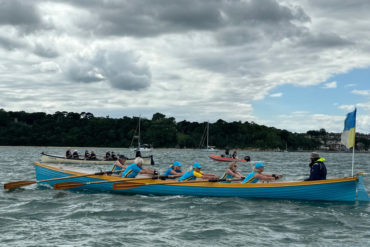 Female gig rowers racing in the solent