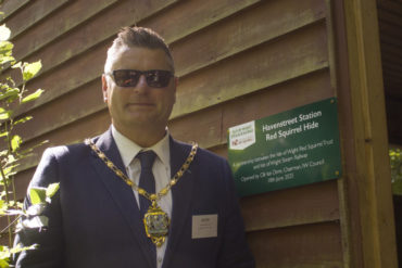 Ian Dore wearing chairman's chain opening the new squirrel hyde at IW Steam Railway