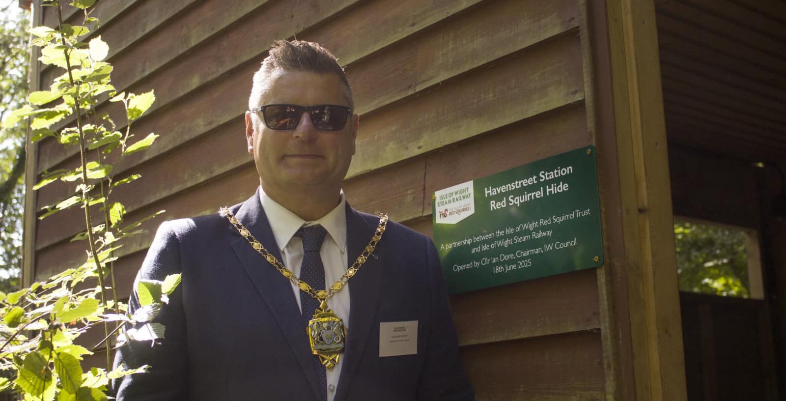 Ian Dore wearing chairman's chain opening the new squirrel hyde at IW Steam Railway