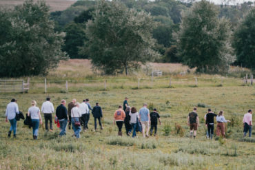 Participants walking across the field at Little Duxmore Farm