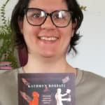Kathryn Rossati holding a copy of her book