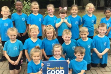 Lanesend Primary School pupils holding 'proud to be good' poster