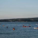 Swimmers and kayakers crossing the Solent by Michael Dangerfield