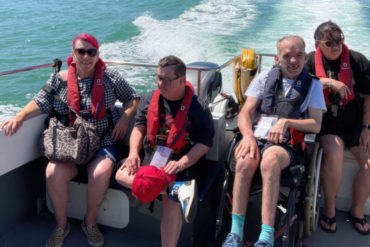 People with disabilities on the wet wheels boat