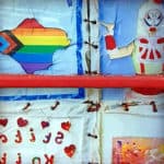 Close up of the AIDS memorial quilt in the window of the phone box