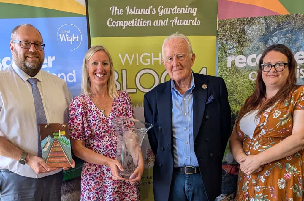 Wight in Bloom 2025 - Simon Moye (Southern Vectis) and Emma Brown (South Western Railway) and Terry Jarman present the Peggy Jarman Trophy to Nicola Fradgley
