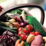 A basket of fresh vegetables and flowers
