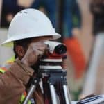 construction worker looking through sightline camera
