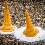 melted ice cream in a cone that has been dropped on the floor
